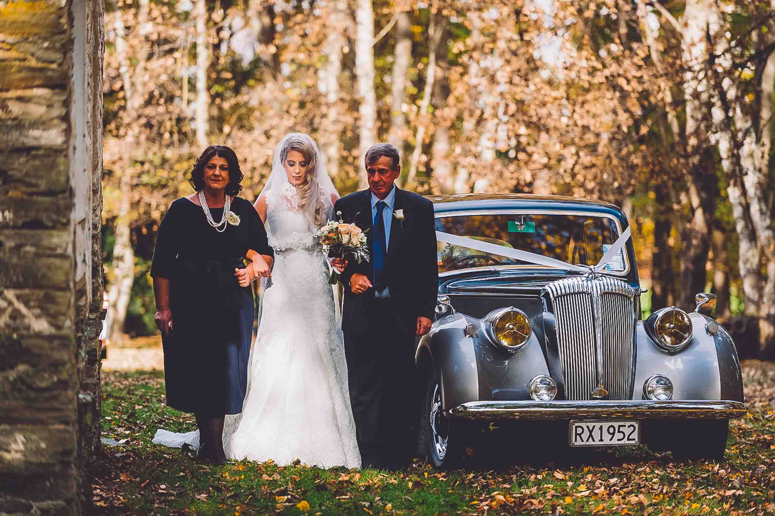 Thurlby Domain bride walking down the aisle vintage wedding car