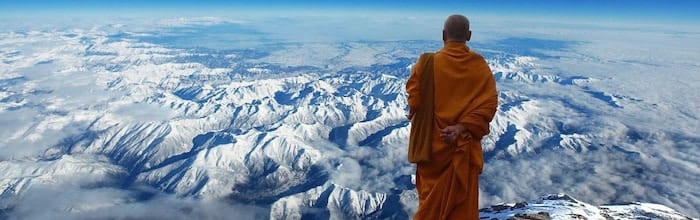 Buddhist-monk-snowy-mountains A Buddhist monk gazes out at the mountains