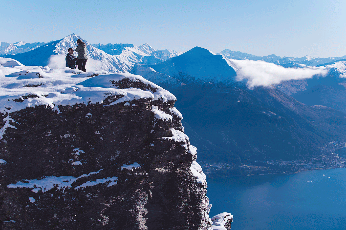 Simon proposes to Kelly during a surprise heli proposal at a snowy Cecil Peak (AKA The Ledge) - Fallon Photography