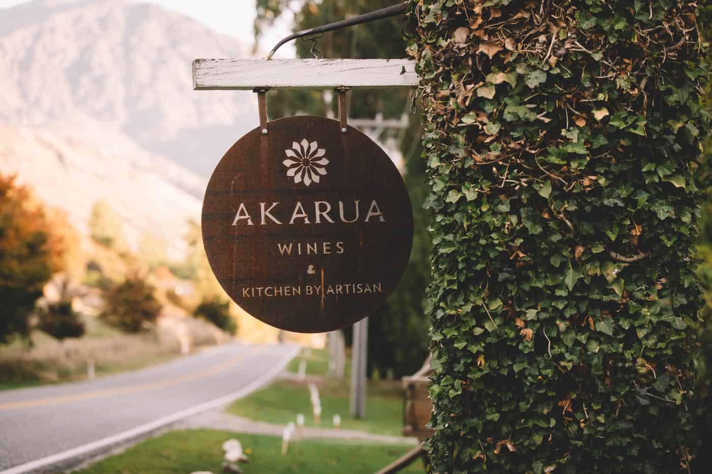Sam and Kirk's Wedding Reception at Akarua Wines and Kitchen by Artisan sign road