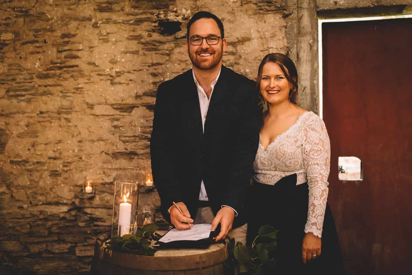 Sam & Kirk's Thurlby Domain Elopement - ceremony in the old stone stables signing the marriage licenses